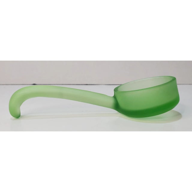 This is a condiment spoon or Mayonnaise spoon. This spoon has a satin finish and curved handle and is indeed uranium...