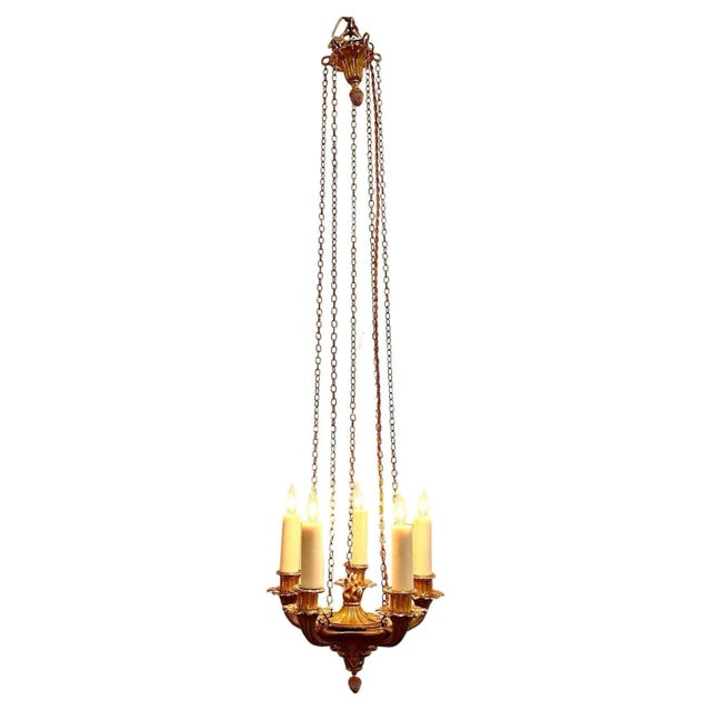 A charming and fine, petite, 5 light, gilded bronze Empire chandelier with chain and canopy. 3.5" off-white wax candle...