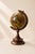 An elegant vintage decorative desktop globe of Italian origin, featuring a finely turned wooden base and a bronze finished...