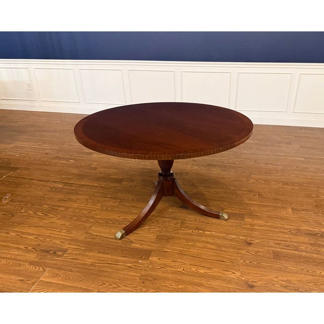 This is 48" round traditional mahogany accent/foyer table made in the Leighton Hall shop. It features a field of cathedral...
