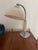 A striking vintage Bauhaus-style desk lamp featuring clean geometric lines, a sculptural chrome frame, and a cream metal...