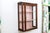 A small antique English mahogany wall-hanging three-sided glass vitrine display cabinet with reddish-brown patina, a...