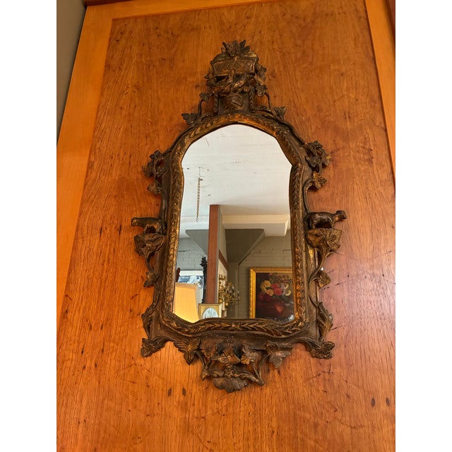 Antique Italian hand-carved gilt-wood patinated mirror in the Baroque style. Intricate high-relief carvings of leaves,...