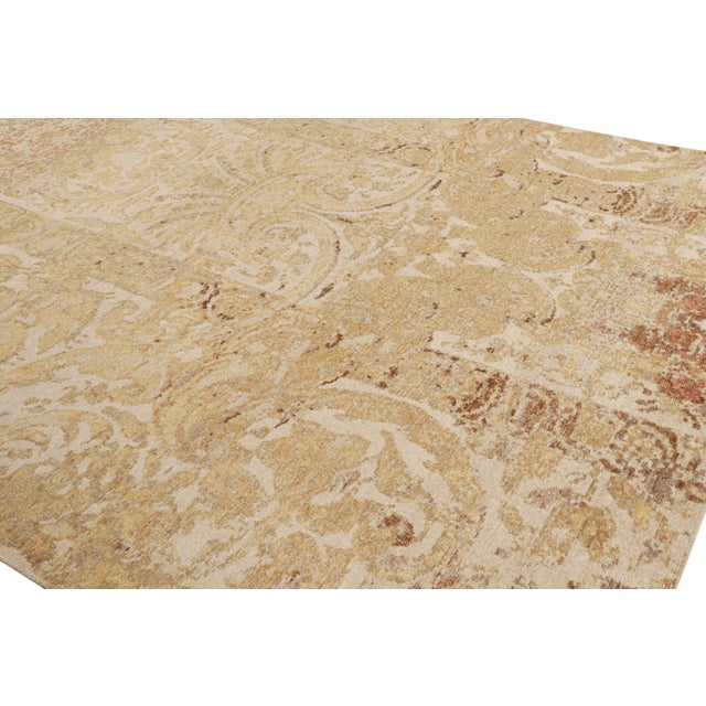 Hand-knotted in wool, this 8x10 modern European rug, originating from India, as inspired by grand European designs of...