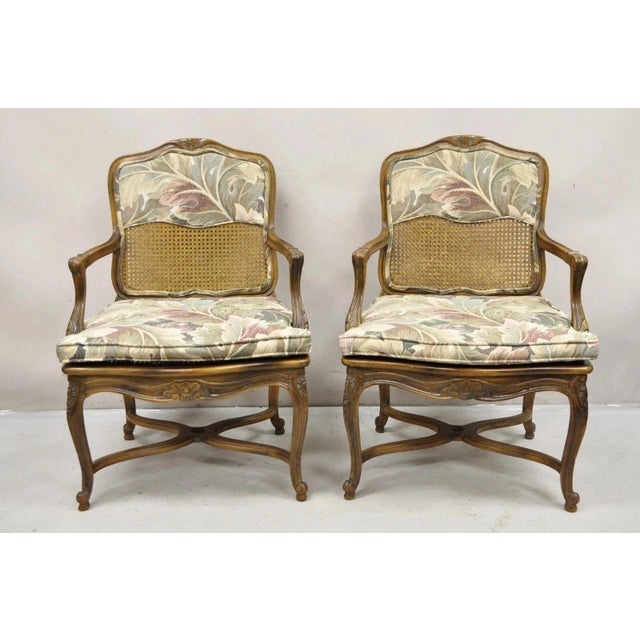 Vintage French Country Louis XV Style Upholstered Cane Stretcher Base Lounge Arm Chairs - a Pair. Circa Mid 20th Century....