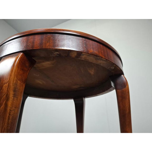 This elegant Art Deco round table was produced in Czechoslovakia in the 1930s. Featuring a beautifully arranged geometric...