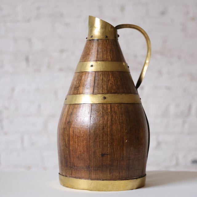 19th-century Normandy cider jug crafted from brass and oak, reflecting the region's rich cider-making heritage. With its...