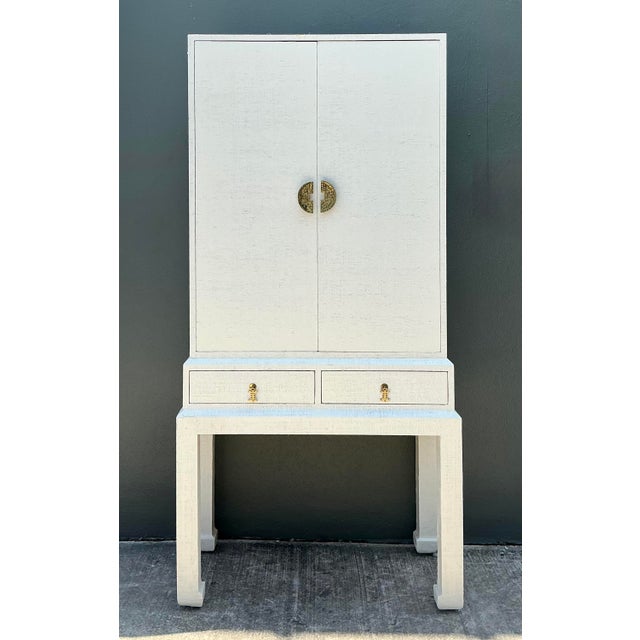 This stunning vintage standing dry bar is a masterclass in Hollywood Regency glamour and Chinoiserie-inspired design....