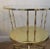 Pair of elegant Italian side tables made of brass and glass. They have two tiers each with spool-type brass columns...