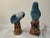 A sweet pair of vintage figural salt and pepper shakers modeled as powder blue parakeets perched on tree stumps. One bows...
