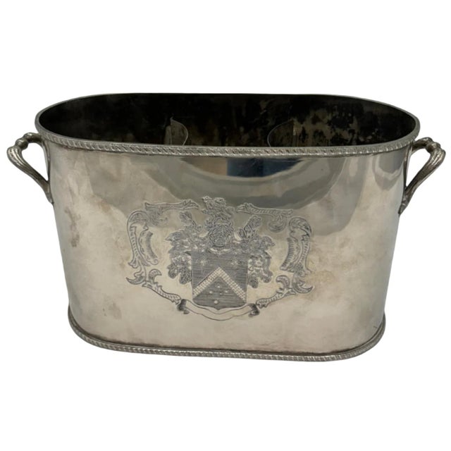 This silver wine holder holds up to 2 bottles and features a decorative crest design. Perfect for displaying your best...