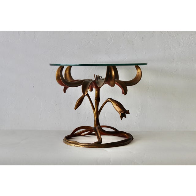 Decorative Art Nouveau style side table in the form of a "Lily". The table is patinated gilt finish over an aluminum base...