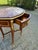 A refined 1960s French Louis XVI–style oval center table, crafted from solid mahogany with gilded bronze accents and an...