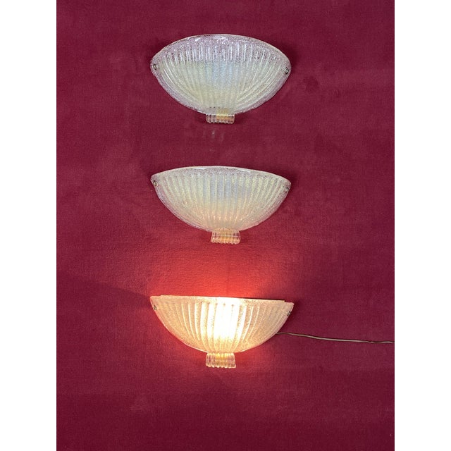 Set of 3 Mid-Century Murano glass wall lamps, 1960s Golden metal structure, E27 lamps Intact and in good condition....