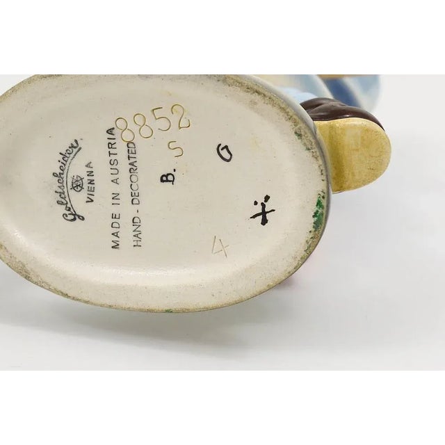 A beautiful and rare Art Deco figuring displaying a girl with umbrella, executed in the 1930s by Friedrich Goldscheider...