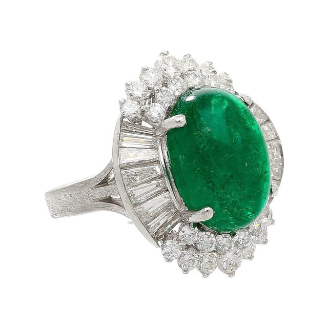 This striking ballerina statement ring features a 5.51 carat emerald cabochon surrounded by 1.83 carats of diamonds in a...