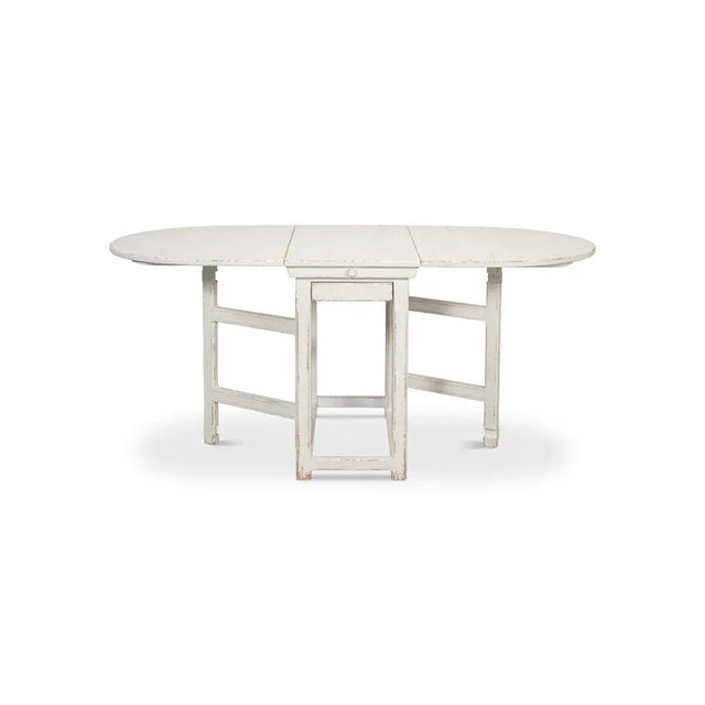 With an initial compact width of 18 inches, this rustic whitewash-painted table gracefully expands to an impressive 69...