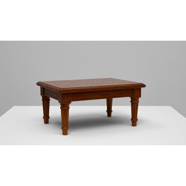 20th Century French wooden pedestal table with geometric top. This refined French table showcases exceptional...