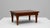 20th Century French wooden pedestal table with geometric top. This refined French table showcases exceptional...