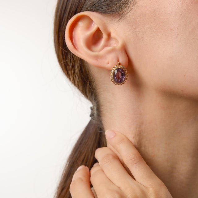 A magnificent pair of turn-of-the-century treasures, these Victorian cluster earrings showcase two richly saturated oval...