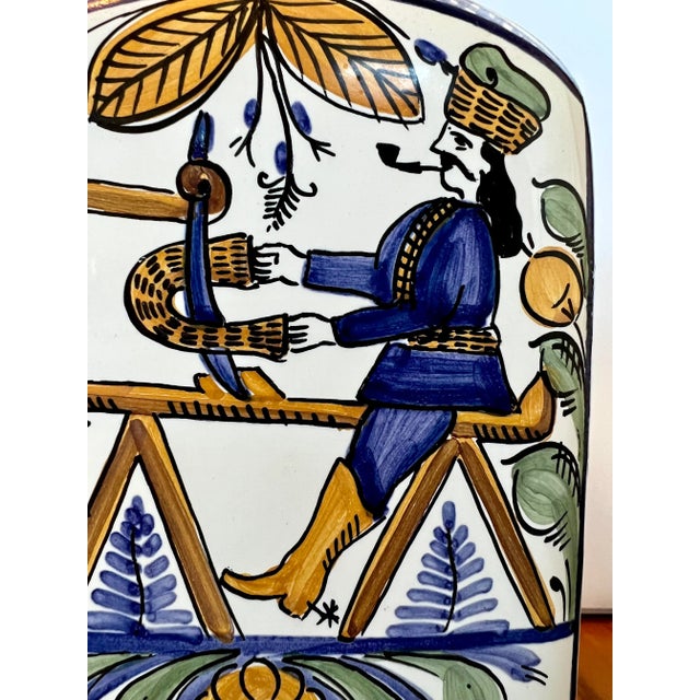 A warm color scheme with adam & eve depicted in a countryside scene. Copper top. Signed base.