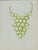 Original hand-drawn jewelry design showing a dramatic bib necklace composed of clustered oval green cabochon stones in...