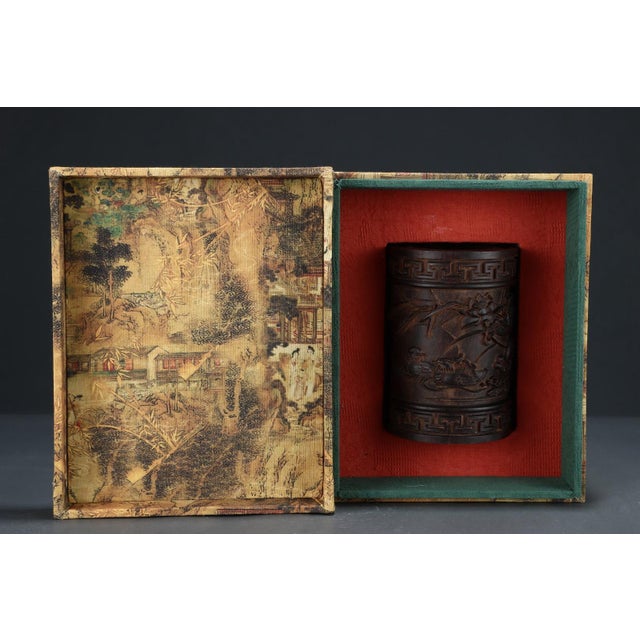 This elegant brush pot is meticulously hand-carved from natural agarwood (Chen Xiang), prized for its rich aroma, fine...