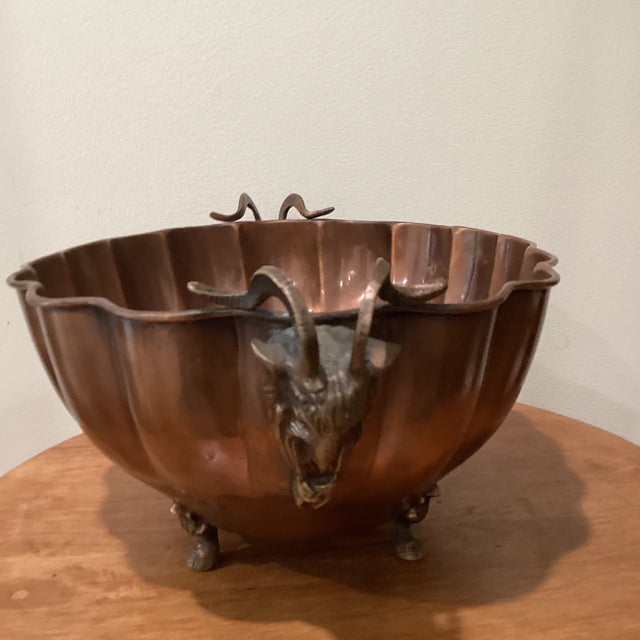 Vintage 1970s brass centerpiece / planter featuring an oval shape with scalloped edges / sides, goat / ram's head handles,...