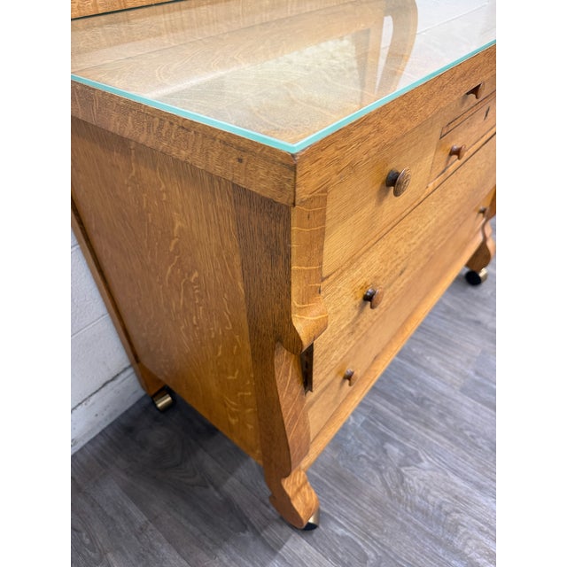 This is a beautiful antique American Empire Revival lowboy dresser or chest of drawers crafted from solid quarter sawn...