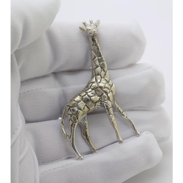 Hailing from the storied silver workshops of Vicenza, Italy, this impressive giraffe figurine captures the precision and...