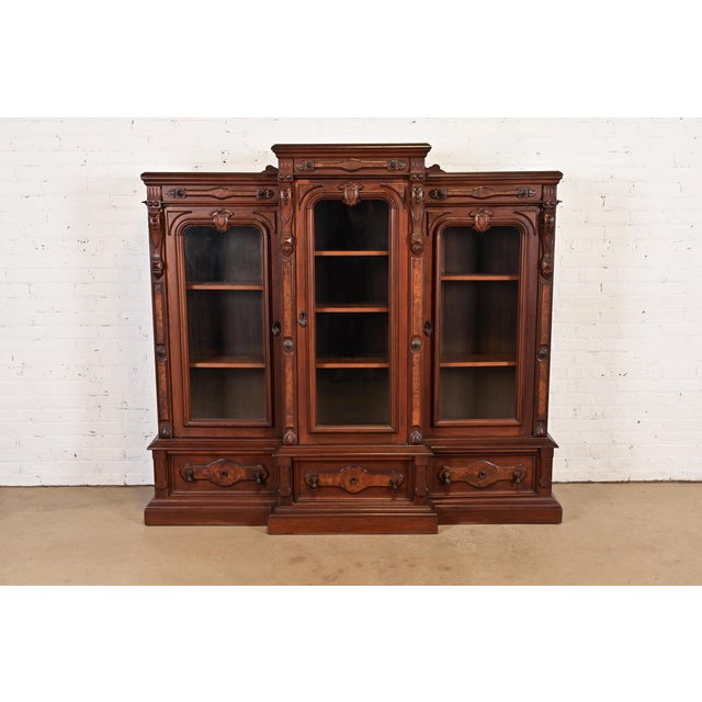 A gorgeous antique Eastlake Victorian or Renaissance Revival triple bookcase cabinet or display cabinet In the manner of...