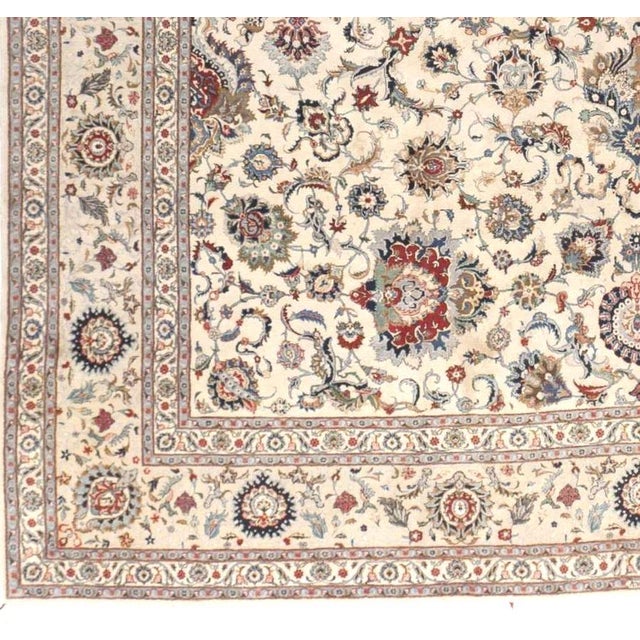 All over floral pattern on ivory background with rare ivory border. Wool pile on cotton foundation. 14'x 22'8"