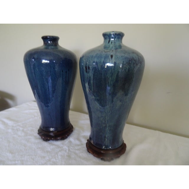 A stunning pair of robbins egg blue Meiping vases from the mid 20th century. The carved stands are newer.
