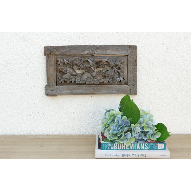 The antique carved wooden panels, likely originating from Southeast Asia, appear to be fragments from a larger...