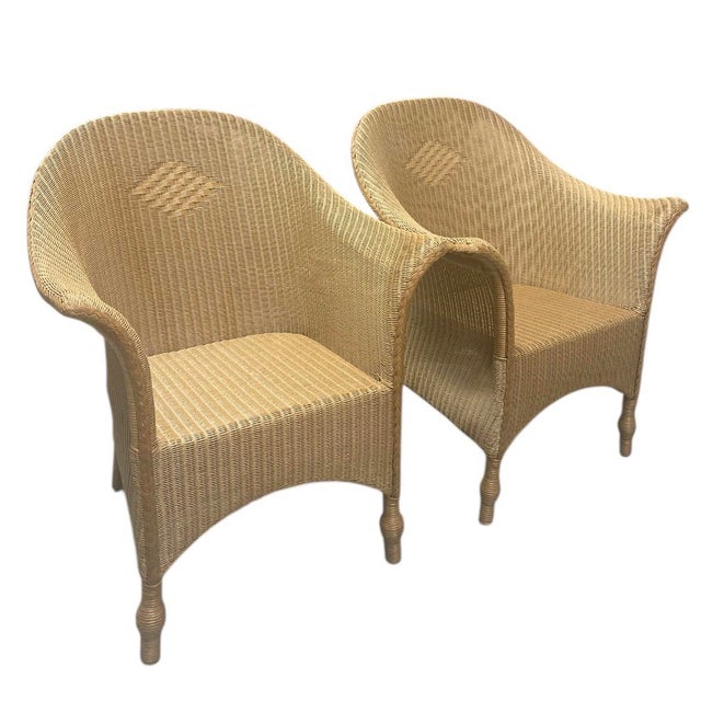 A striking pair of sculptural wicker club chairs, perfect for a sunroom, covered porch, or relaxed coastal interior. These...