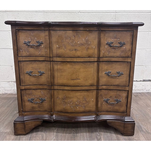 This is a gorgeous French Provincial-style bombe chest featuring a shaped serpentine front, three spacious drawers, floral...