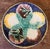 Antique majolica plate in a starfish and scallops pattern over a cobalt blue background and yellow rim.