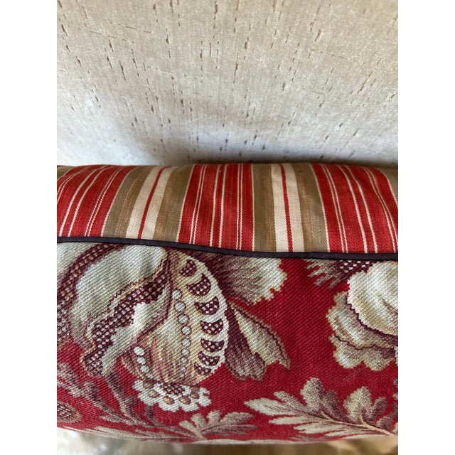 A pillow made from an early 20th century French printed cotton and backed with antique ticking stripe