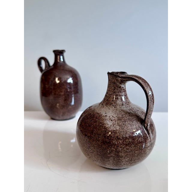 A pair of handcrafted handled vases from the Serocka workshop, executed in their characteristic speckled brown and natural...