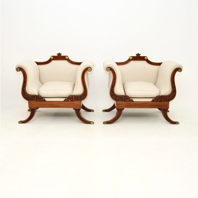 A stunning and very impressive pair of large antique Regency style armchairs. They were made in England, we would date...