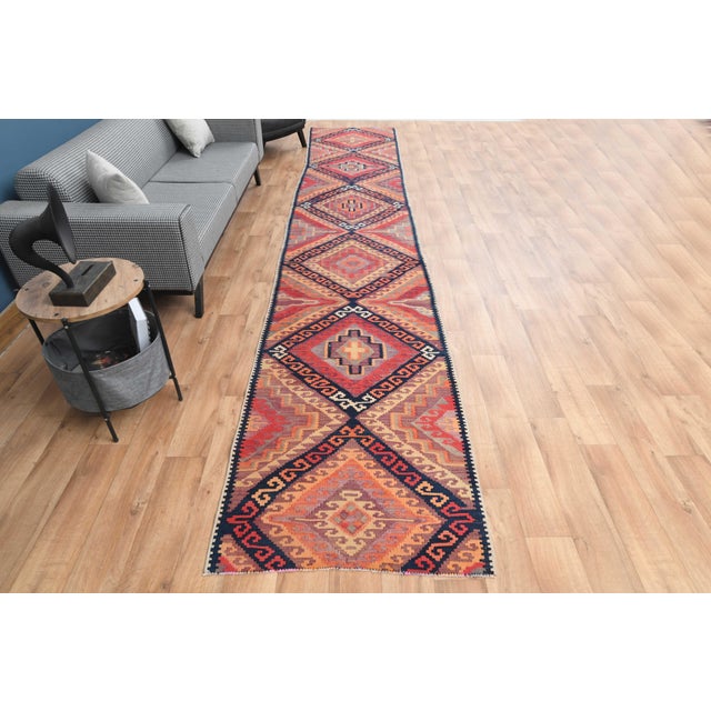 Vintage Hand-Knotted runner rug is a semi-antique vintage area rug. The '70s Eastern region of Anatolia's unique rug is...