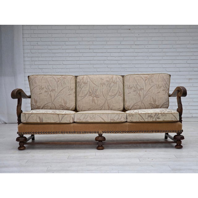 1960s, Danish 3-seater sofa. Beige/brown furniture fabric, carved oak wood, springs in the seat cushions. Sofa was...
