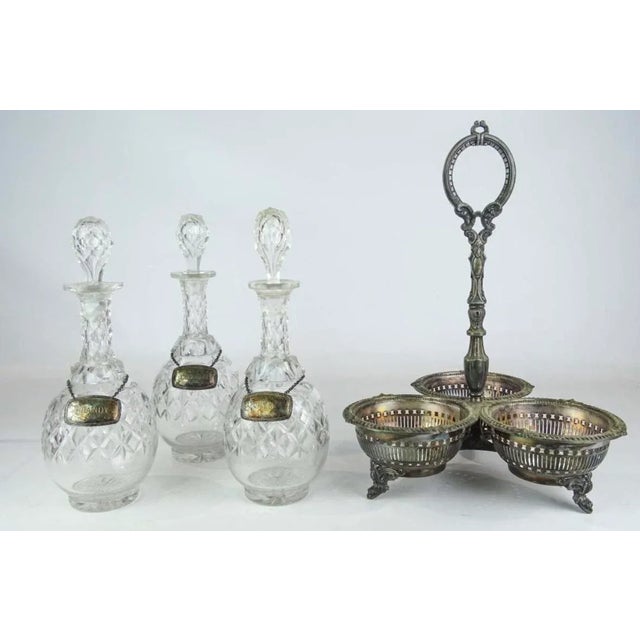 Great for entertaining. A three decanter Edwardian silver plate holder Makes for portable liquor service. Three liquor...