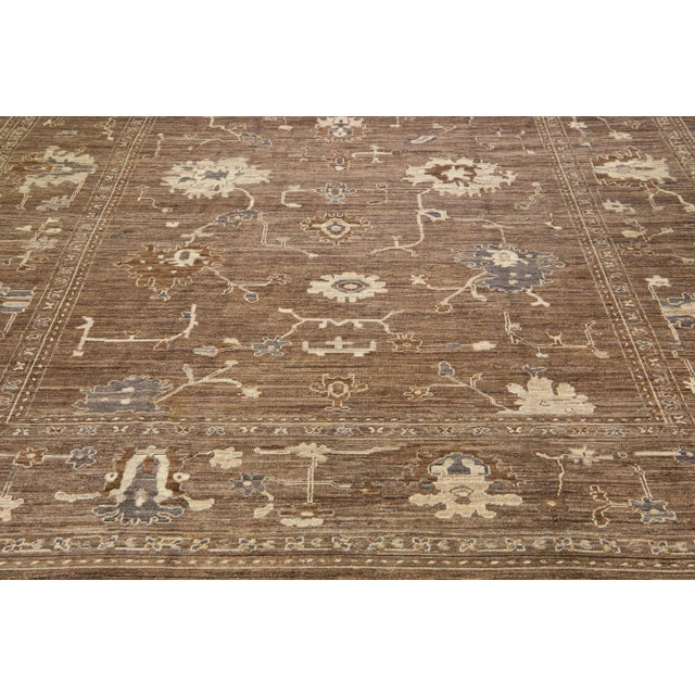 Beautiful contemporary Oushak hand-knotted wool rug with a brown color field. This Oushak rug has a scattered beige and...