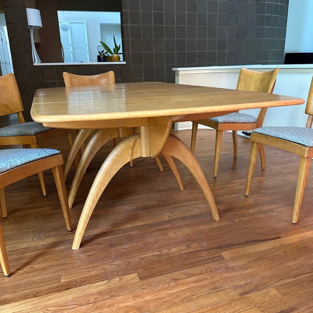 Complete vintage Heywood-Wakefield dining suite featuring an expandable wishbone-style table and six matching chairs,...