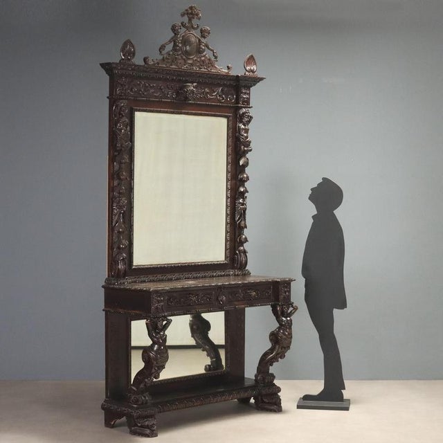 Italian Neobaroque console from the late 19th century, featuring a richly carved and ebonized structure. The console is...