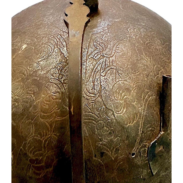 This artifact is an Indo-Persian Kulah Khud helmet, a traditional style of head armor used across Persia, India, and the...