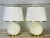 Vintage early 1970s round cream and gold accented pair of table lamps. The lamps come with the original shades. The lamps...