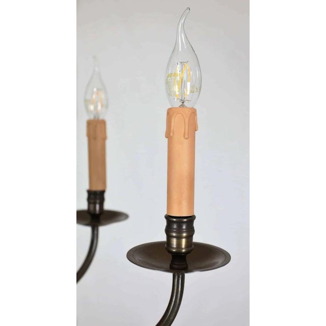 Eight-armed bronze chandelier with a beautiful patina. The chandelier has been completely renovated: new electrical...