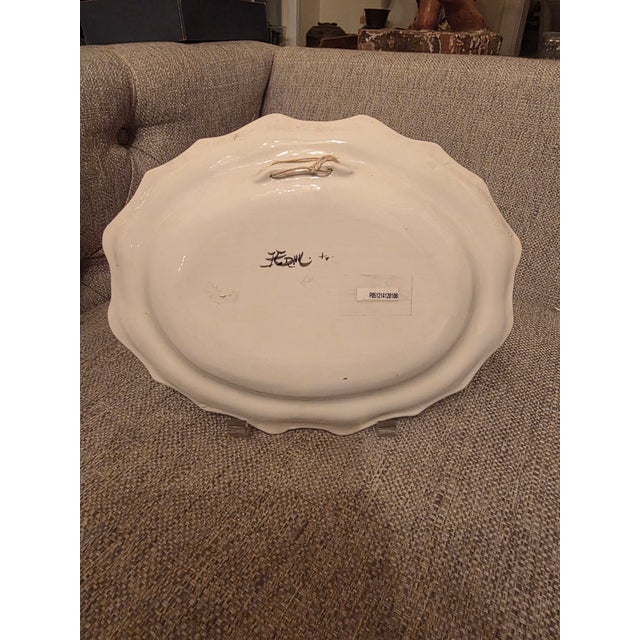 Traditional French Faience Moustiers Platter featuring a bird surrounded by floral decoration. This has a hanger mechanism...